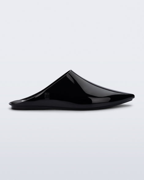 Side view of a black She slip on with pointed toe