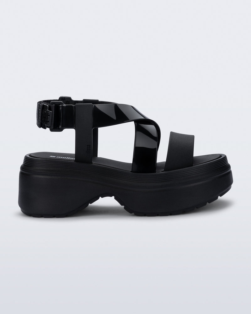 Side view of a black Stand platform sandal