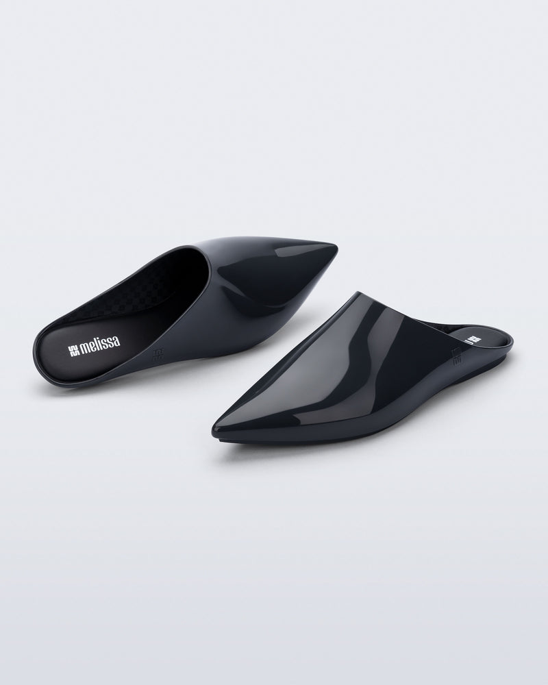 Top and angled view of a pair of grey She slip ons with pointed toe
