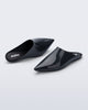 Top and angled view of a pair of grey She slip ons with pointed toe
