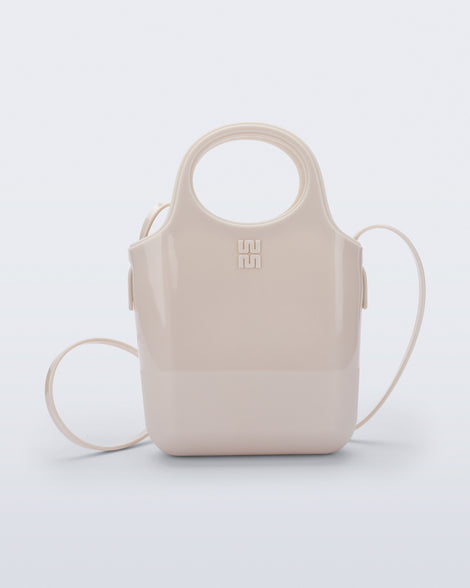 Front view of a beige Ultra Bag with handle and strap