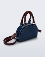 Angled view of a blue Bowling bag with burgundy handle strap and cross body strap