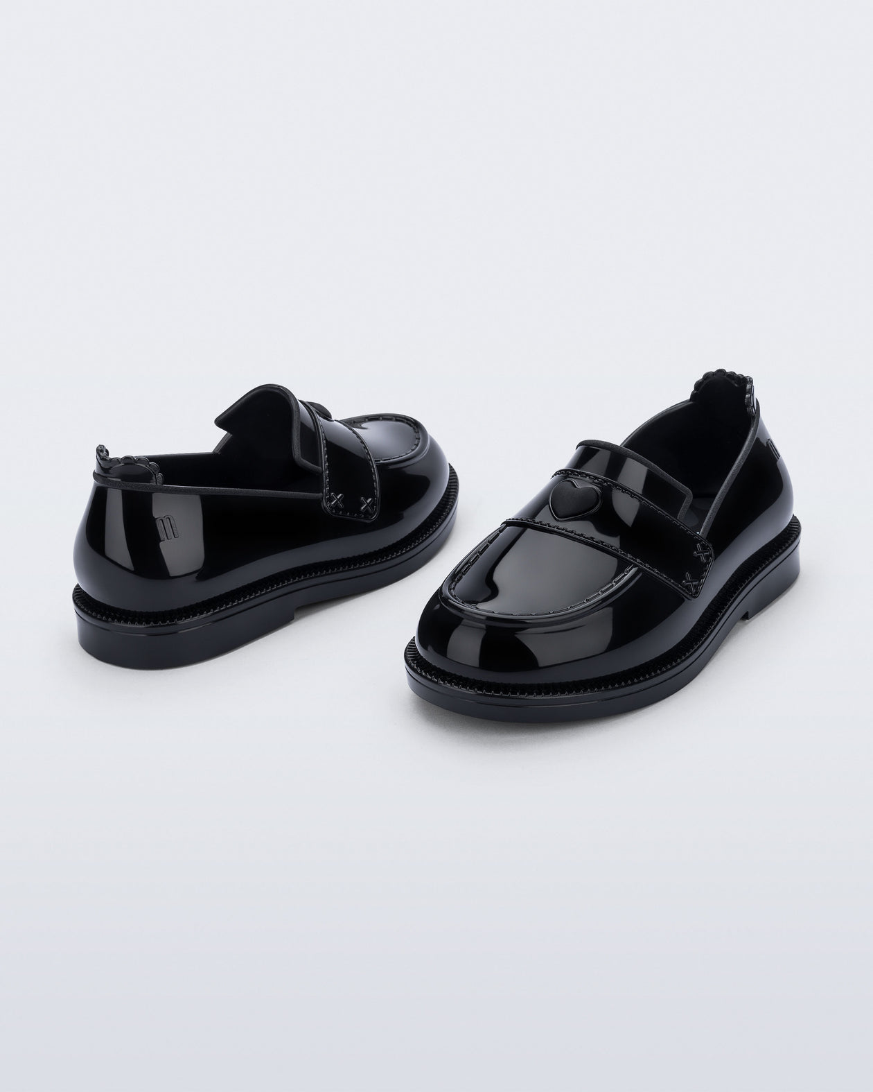 Back and angled view of a pair of black Royal Love baby loafers