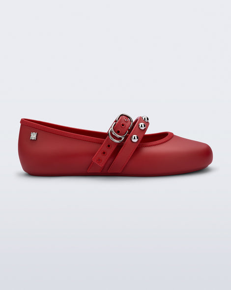 Side view of a red Soft Ballerina Studs flat with silver embellishments