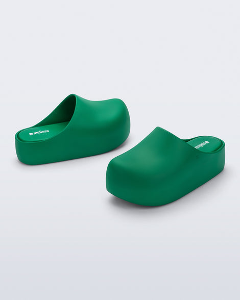 Side and angled view of a pair of green Free Clog Up Platforms