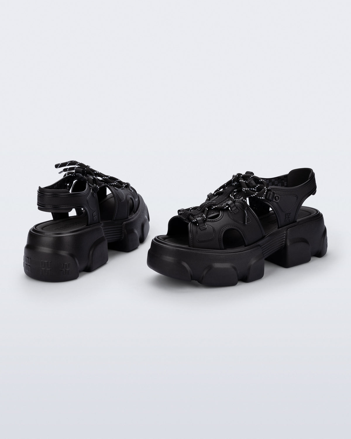 Back and angled view of a pair of black Camp platform sandals with black laces