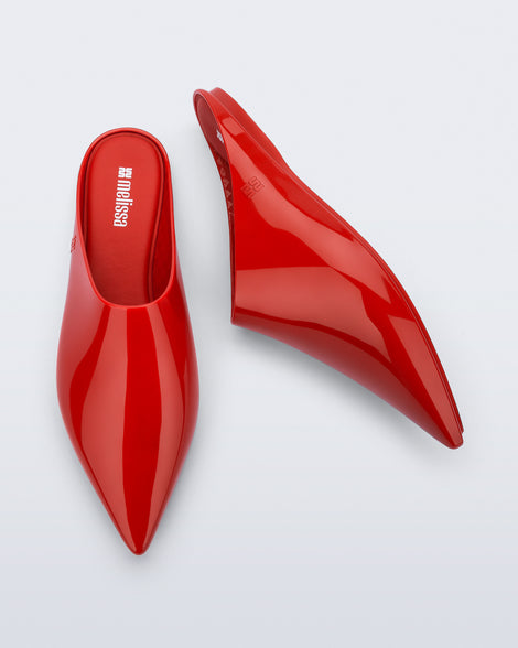 Top and side view of a pair of red She slip ons with pointed toe
