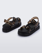 Back and angled view of a pair of black Cozy Sandal Platforms with clear leopard print straps