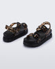 Back and angled view of a pair of black Cozy Sandal Platforms with clear leopard print straps