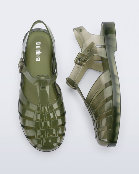 Top and side view of a pair of clear dark green Possession fisherman sandals