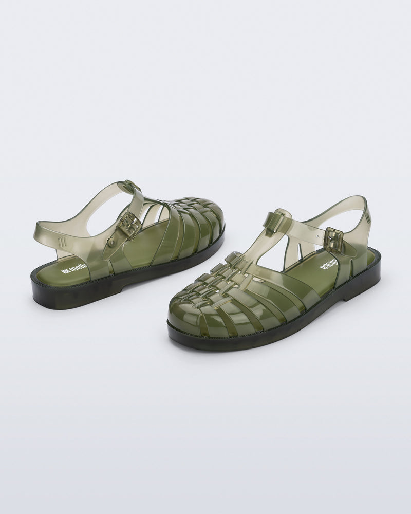 Back and angled view of a pair of clear dark green Possession fisherman sandals