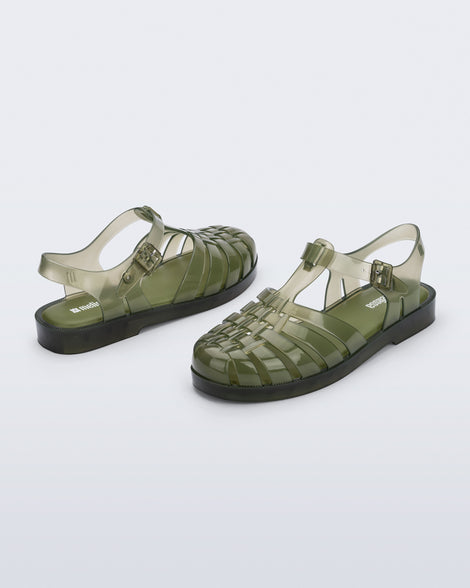 Back and angled view of a pair of clear dark green Possession fisherman sandals