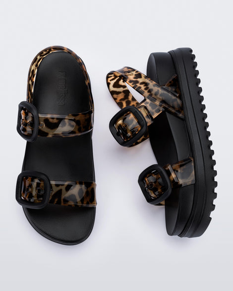 Top and side view of a pair of black Cozy Sandal Platforms with clear leopard print straps