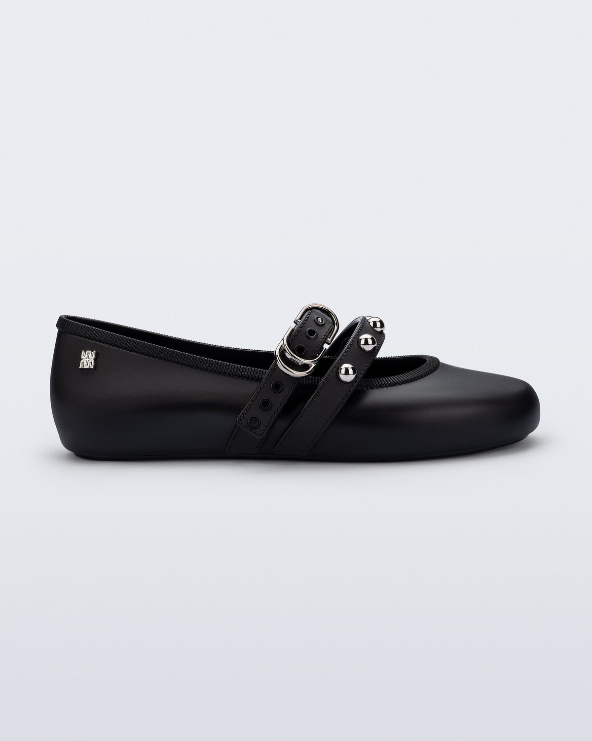 Side view of a black Soft Ballerina Studs flat with silver embellishments