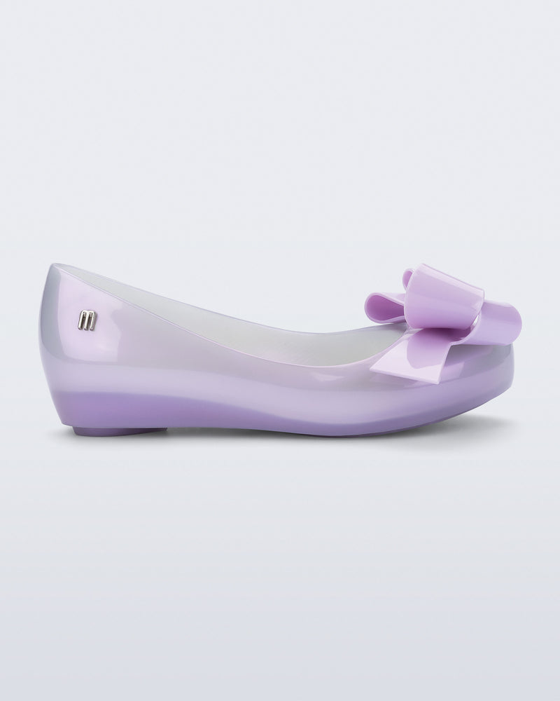 Side view of a pearly lilac Ultragirl Classy kids flat with lilac bow