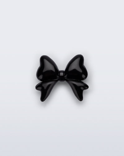 Front view of a black bow shoe charm