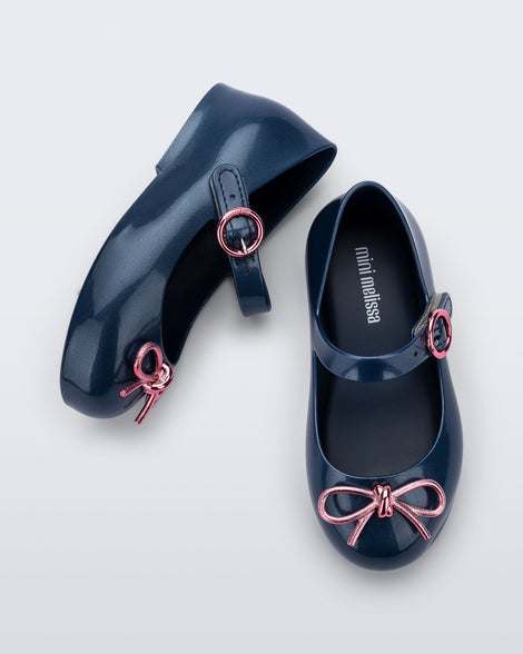 Top and side view of a pair of blue Sweet Love Chrome baby flats with metallic pink bow and buckle