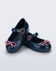 Angled view of a pair of blue Sweet Love Chrome baby flats with metallic pink bow and buckle