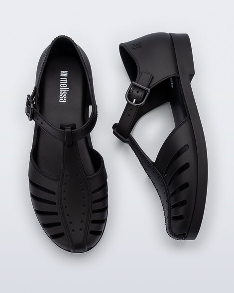 Top and side view of a pair of black Aranha 79 flats with buckle