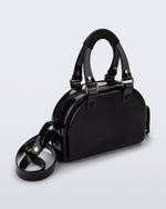 Angled view of a black Bowling bag with handle straps and cross body strap