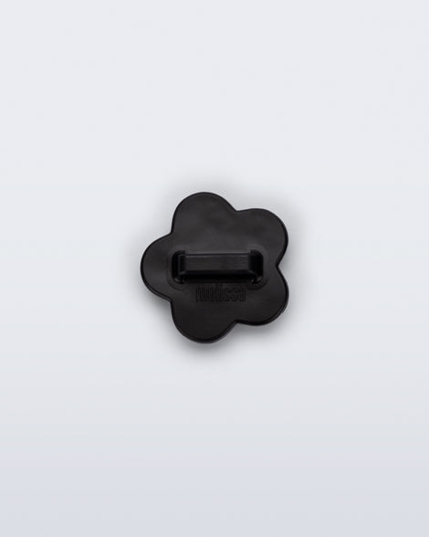 Back view of a black flower shoe charm