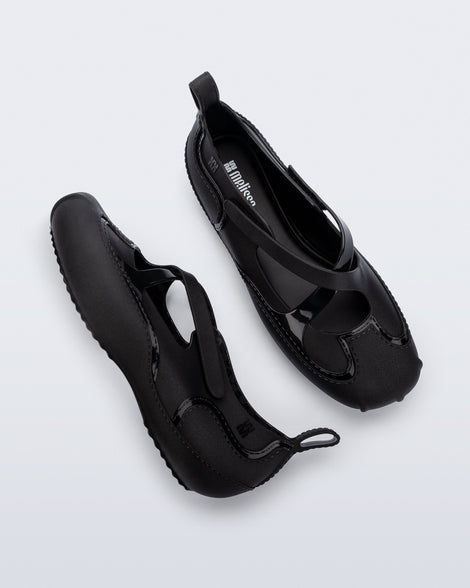 Top and side view of a pair of black Aira flats with top straps