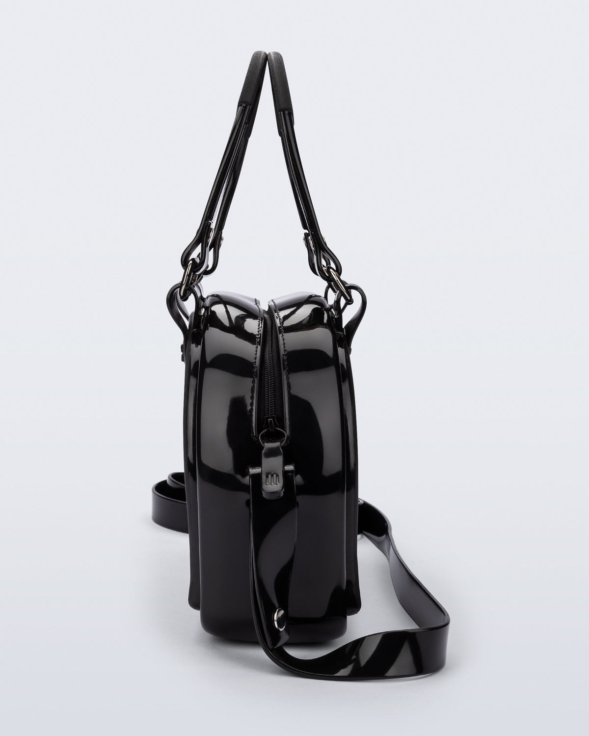 Side view of a black Bowling bag with handle strap and cross body strap