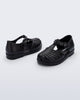 Side and angled view of a pair of black Aranha 79 baby flats with buckle