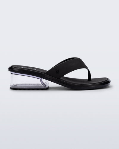 Side view of a black Margot flip flop with clear low heel 