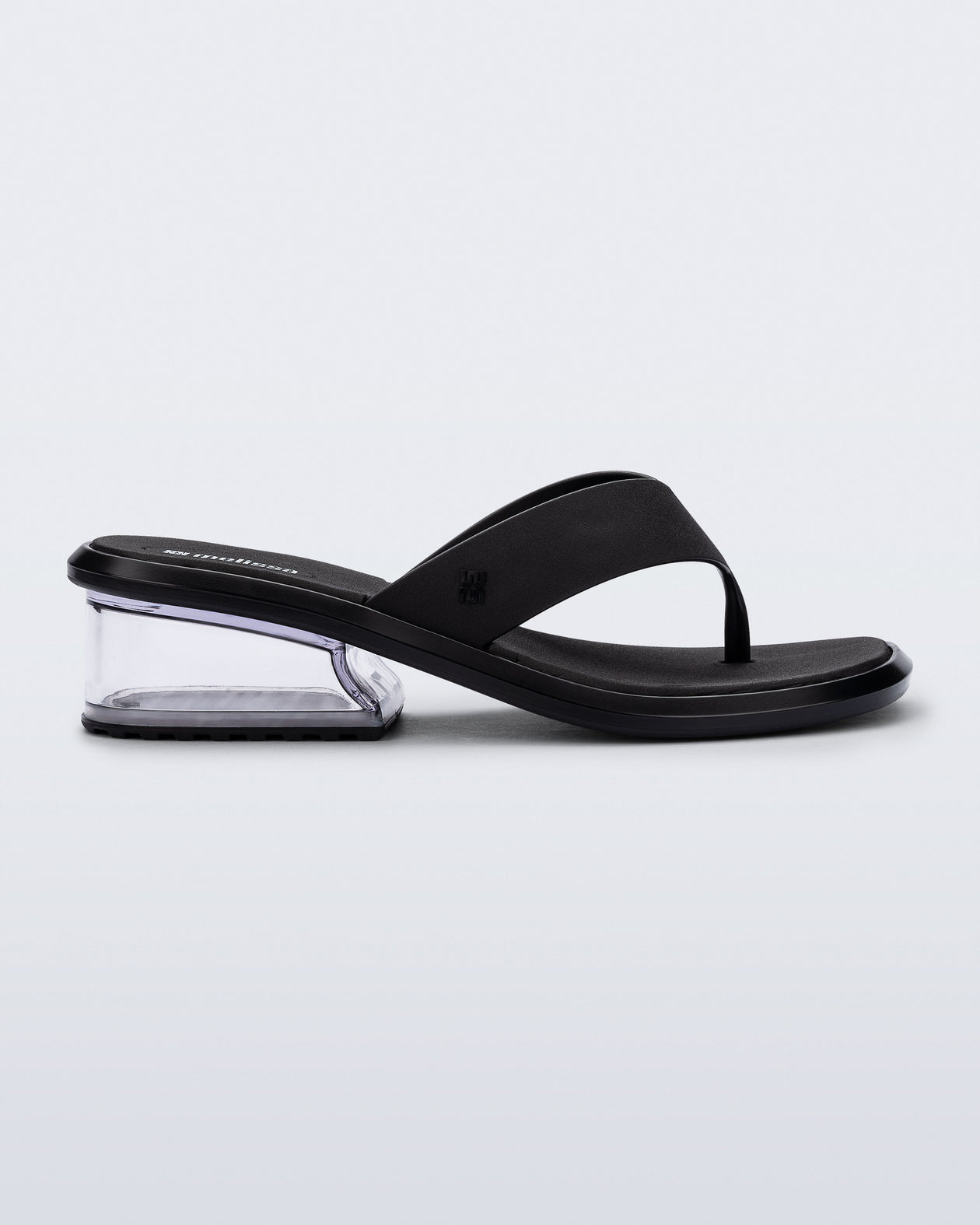 Side view of a black Margot flip flop with clear low heel 