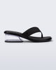 Side view of a black Margot flip flop with clear low heel 