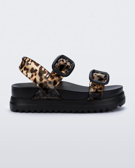 Side view of a black Cozy Sandal Platform with clear leopard print straps