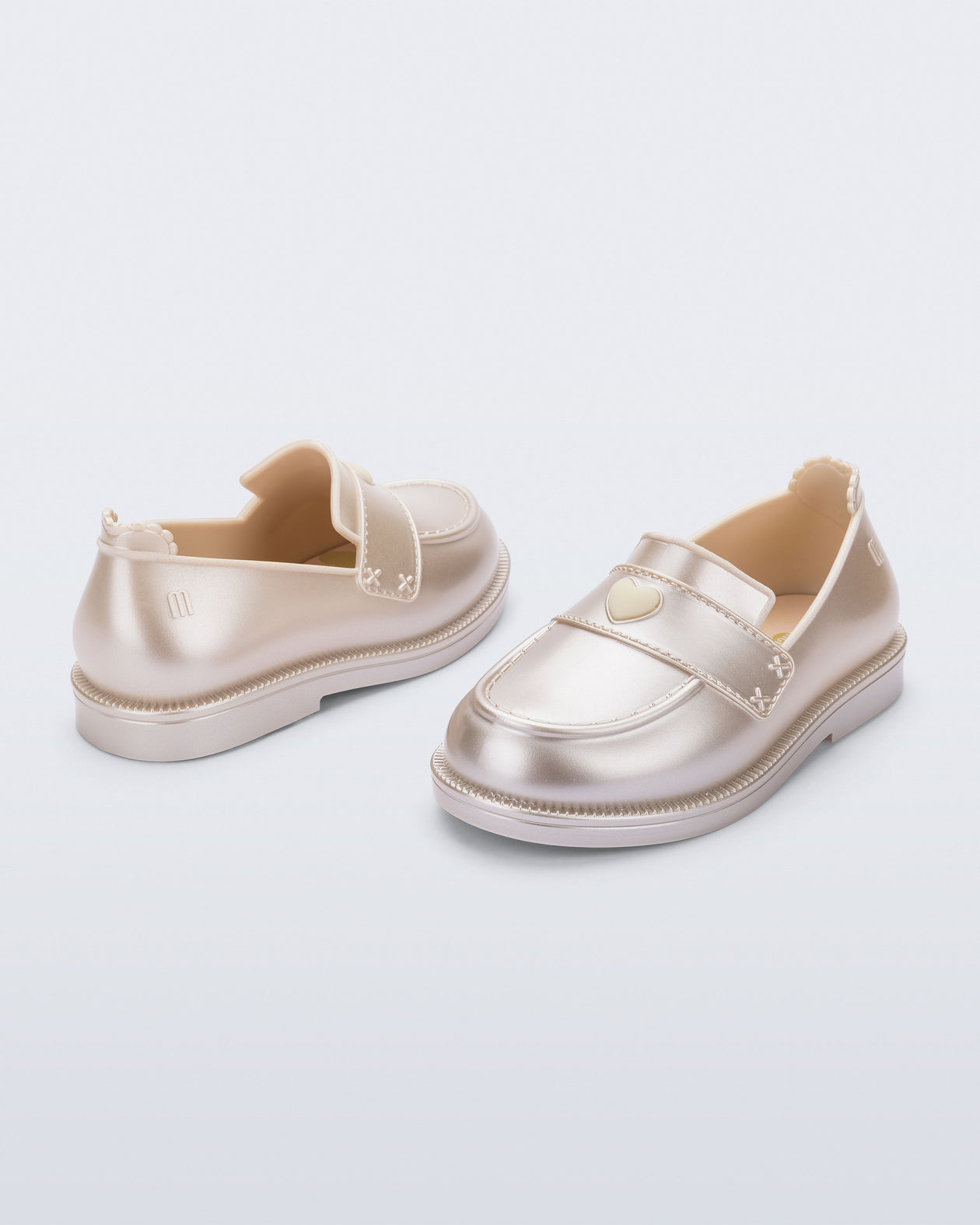 Back and angled view of a pair of metallic beige Royal Love baby loafers