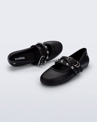 Top and angled view of a pair of black Soft Ballerina Studs flats with silver embellishments