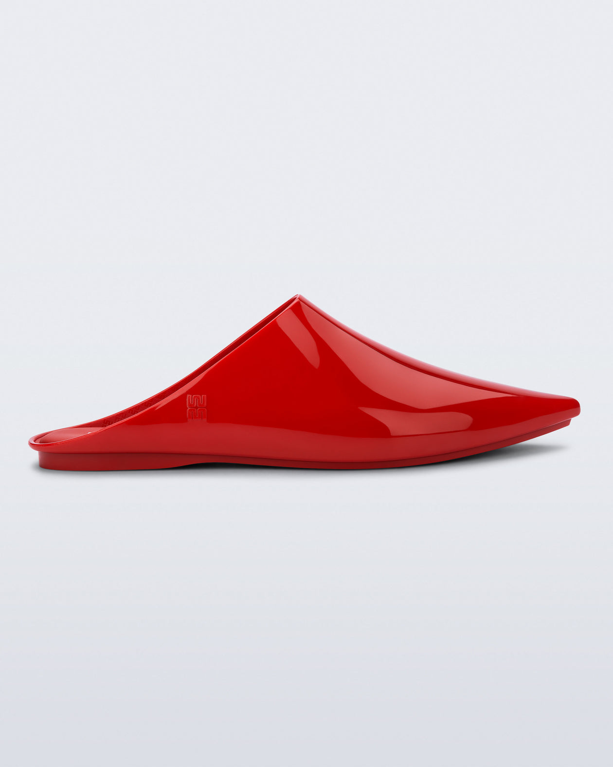 Side view of a red She slip on with pointed toe
