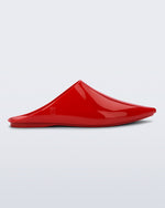 Side view of a red She slip on with pointed toe