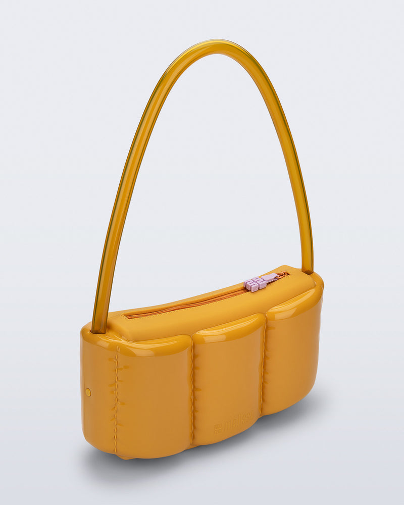 Angled view of a yellow Airflow bag with clear shoulder strap