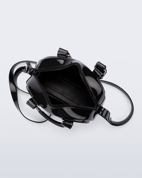 Top view of a black Bowling bag with handle strap and cross body strap