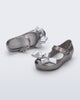 Top and angled view of a pair of silver glitter Ultragirl Classy baby flats with silver bow