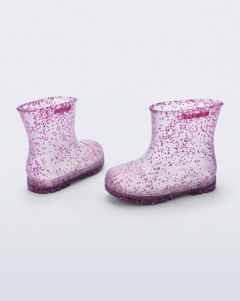 Back and side view of a pair of clear with pink glitter Welly baby rain boots