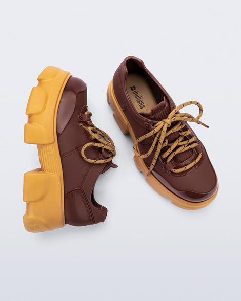 Top and side view of a pair of brown Camp platform Sneakers with yellow laces and sole