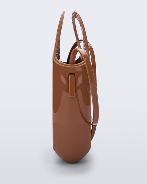 Side view of a light brown Ultra Bag with handle and strap