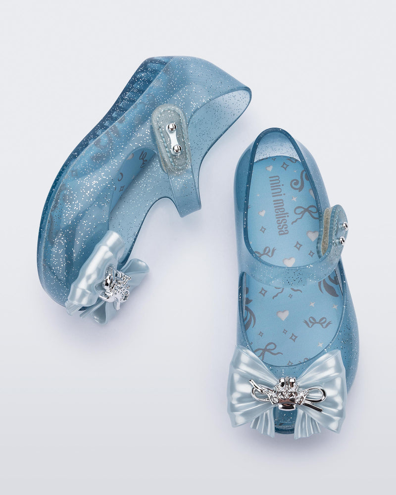 Top and side view of a pair of glitter blue Ultragirl Princess ballerina baby flats with bow on top and silver details