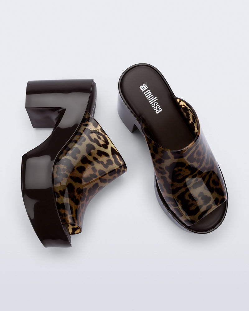 Top and side view of a pair of black Mule Hype platforms with clear cheetah upper
