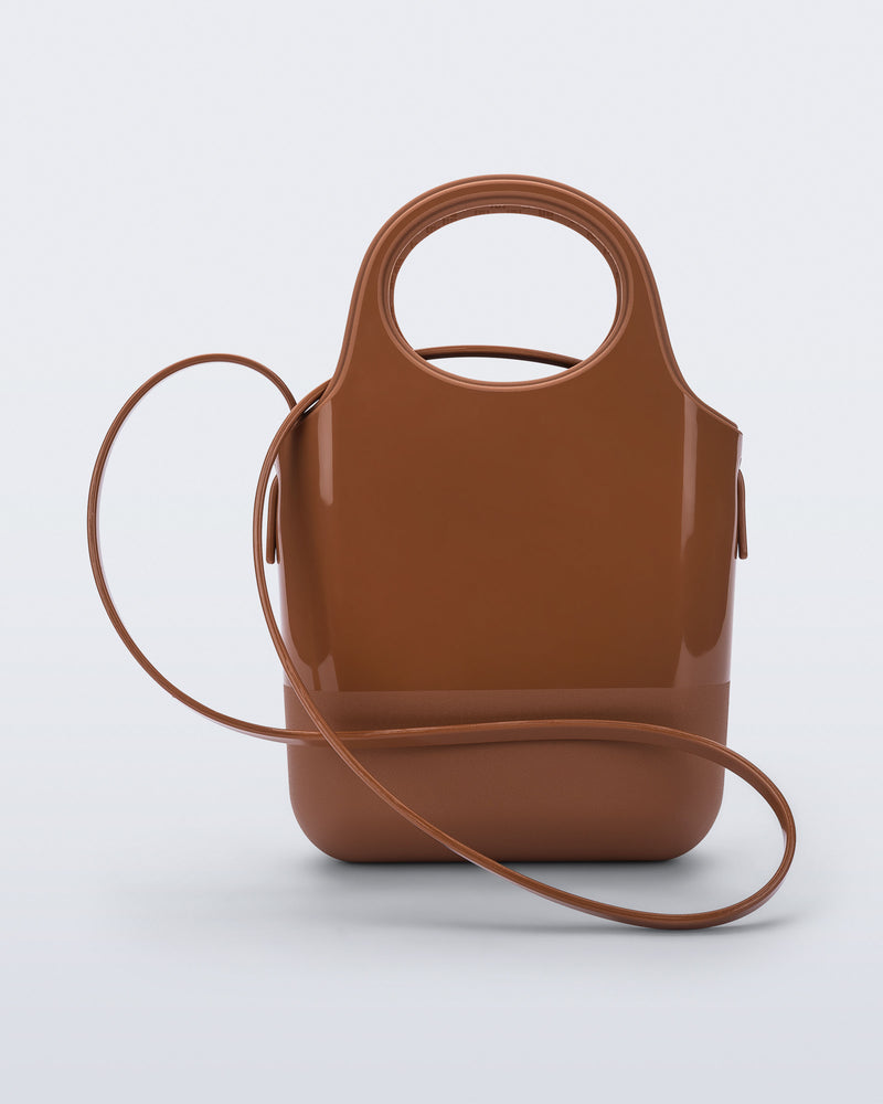 Back view of a light brown Ultra Bag with handle and strap