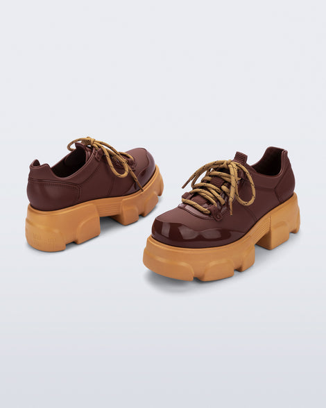 Back and angled view of a pair of brown Camp platform Sneakers with yellow laces and sole