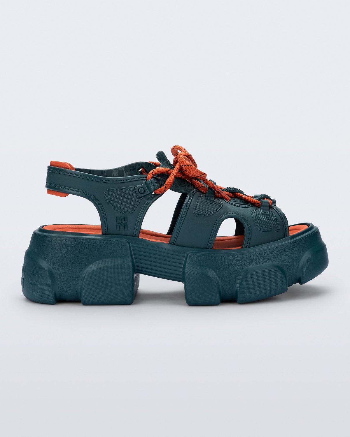side view of a blue Camp platform sandal with orange laces and accents