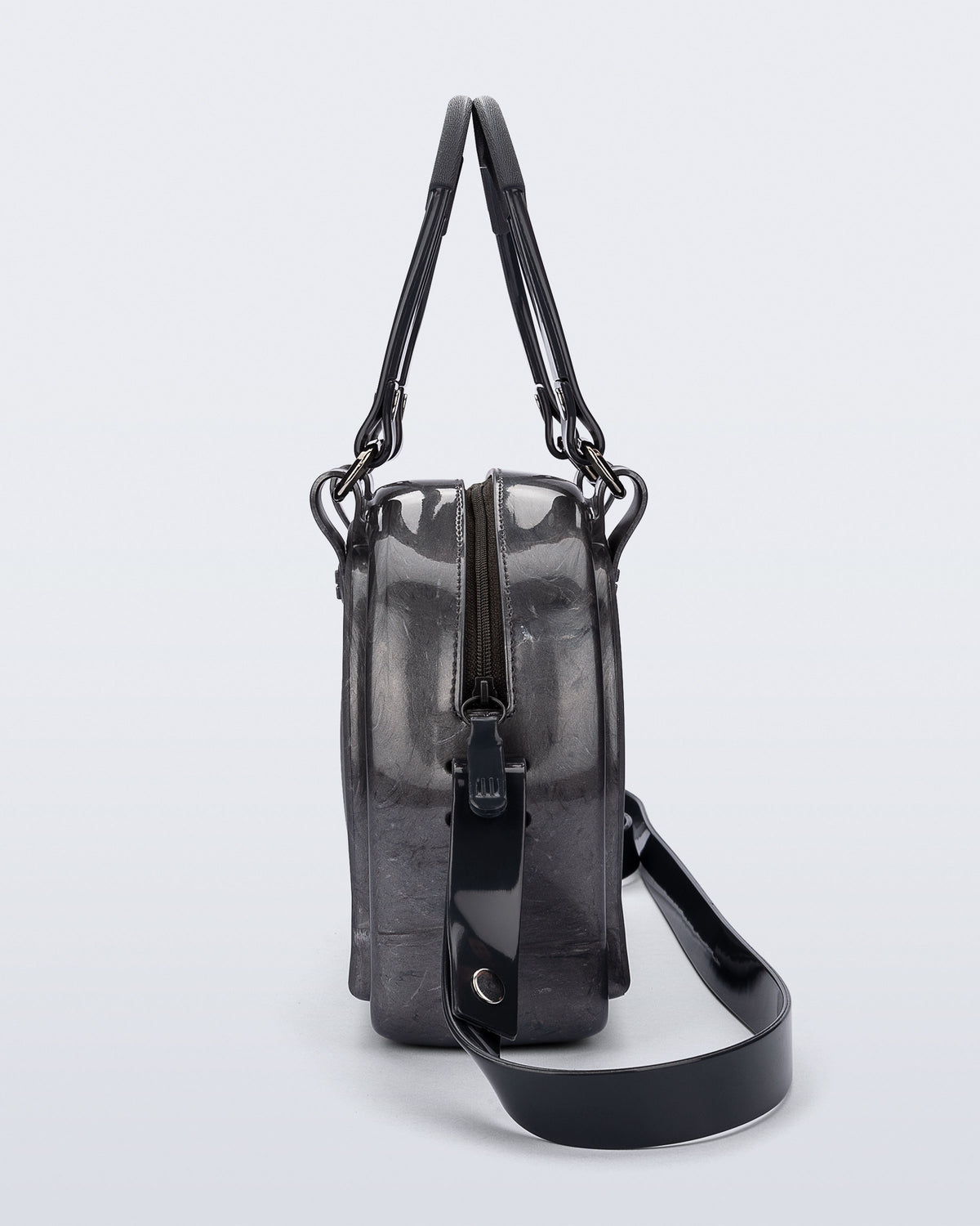 Side view of a grey Bowling bag with black handle strap and cross body strap