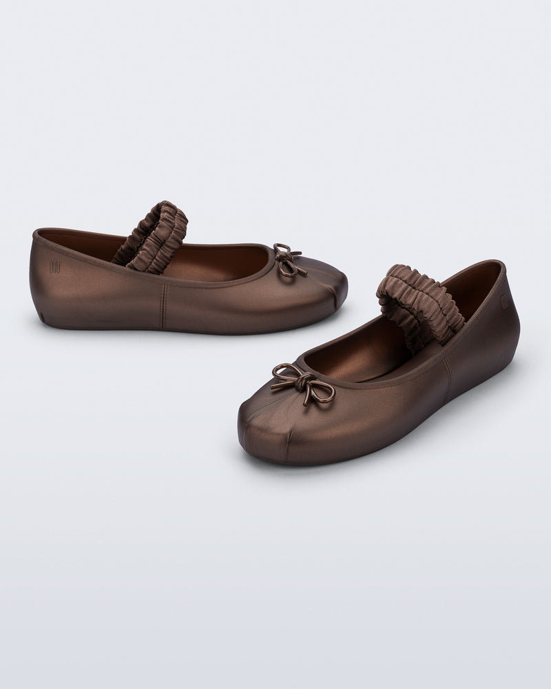 Side and angled view of a pair of bronze Sophie Scrunch flats
