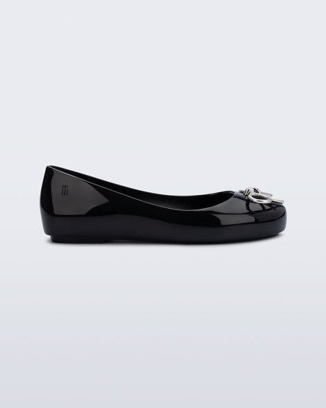 Side view of a black Sweet Love Chrome kids flat with metallic silver bow